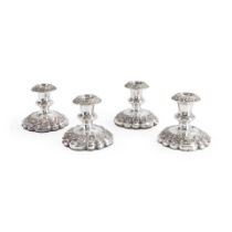 FOUR ENGLISH SHEFFIELD SILVER-PLATED WEIGHTED LOW CANDLESTICKS