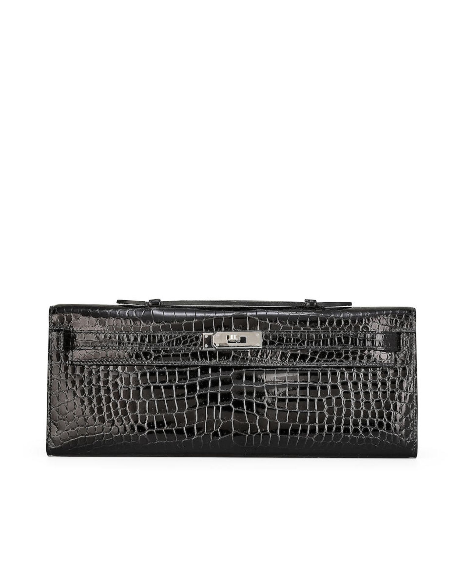 HERMÈS: BLACK SHINY CROCODILE POROSUS KELLY CUT WITH PALLADIUM HARDWARE (Includes original ...