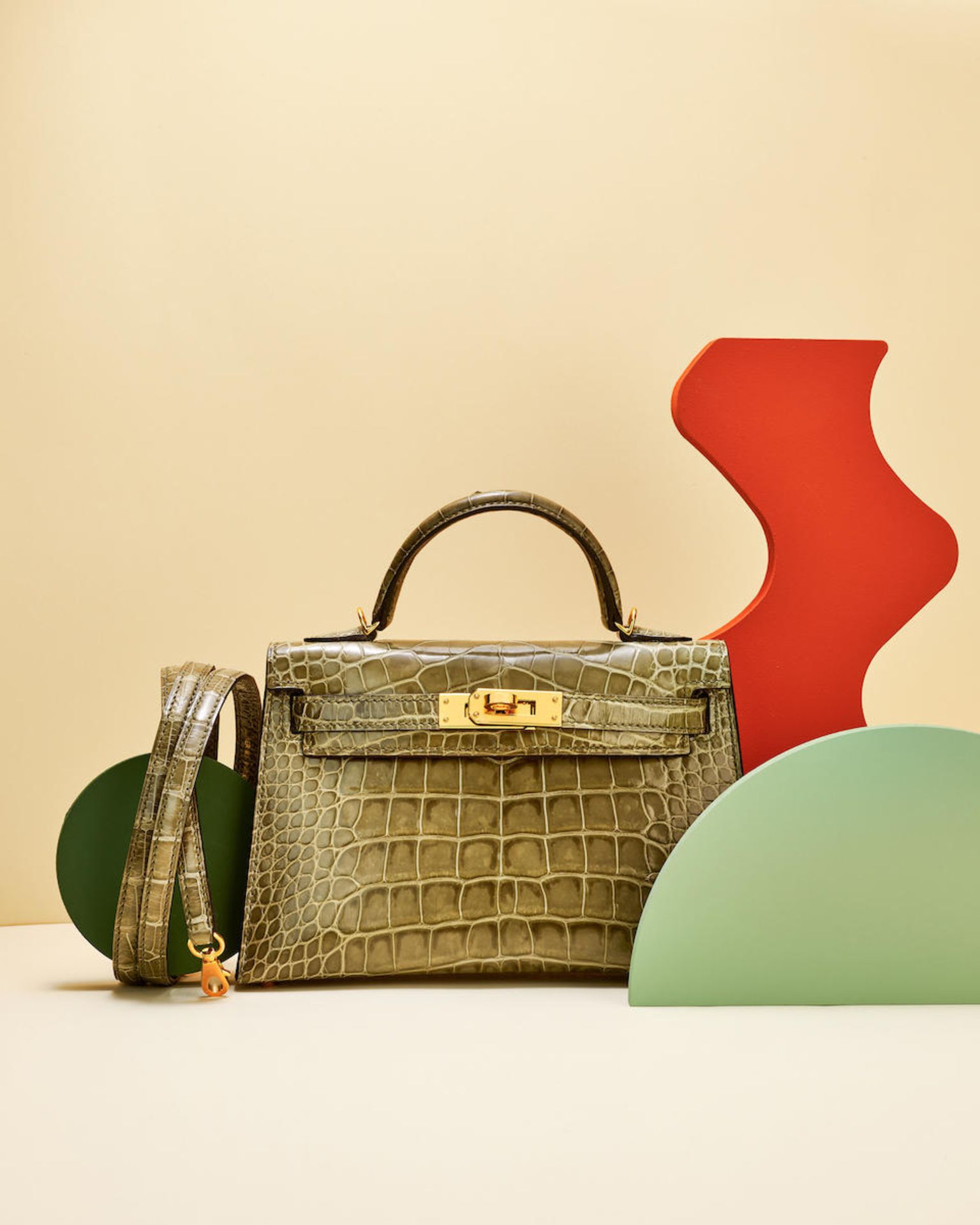 HERMÈS: GRIS TOURTERELLE SHINY ALLIGATOR MINI KELLY II WITH GOLD HARDWARE (Includes strap, ...