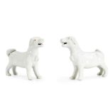 A PAIR OF EXPORT WHITE-GLAZED DOGS