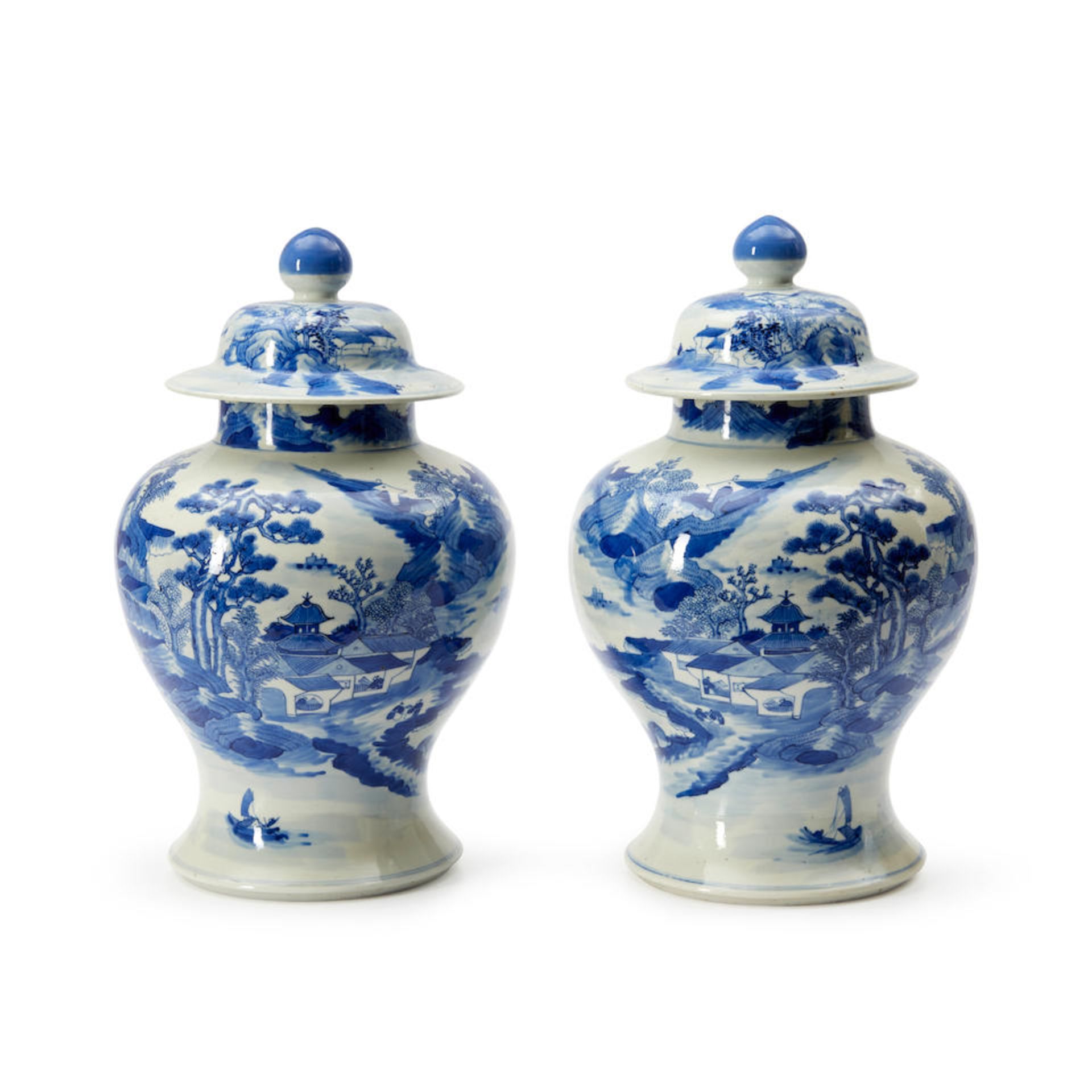 A NEAR PAIR OF BLUE AND WHITE 'LANDSCAPE' JARS AND COVERS
