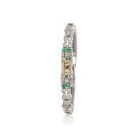 A fine lady's 18K white gold manual wind bracelet watch with diamond and emerald set bezel Belle...