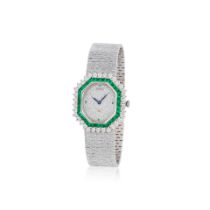 Piaget. A fine lady's 18K white gold manual wind bracelet watch with diamond and emerald set dia...