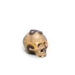 A CERAMIC OKIMONO (TABLE ORNAMENT) OF A SKULL AND SNAKE Taisho (1912-1926) or Showa (1926-1989) ...