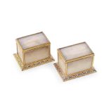 A pair of late 19th French champlevé and gilt bronze mounted cream onyx stamp boxes by Alph...