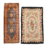 TWO RUGS: A KAYSERI YOLLUK SILK RUG AND A HAND HOOKED RUG