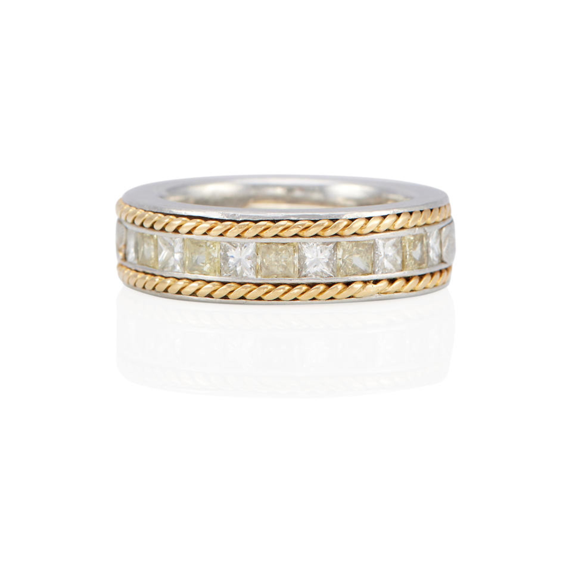 A PLATINUM, 18K GOLD AND DIAMOND BAND