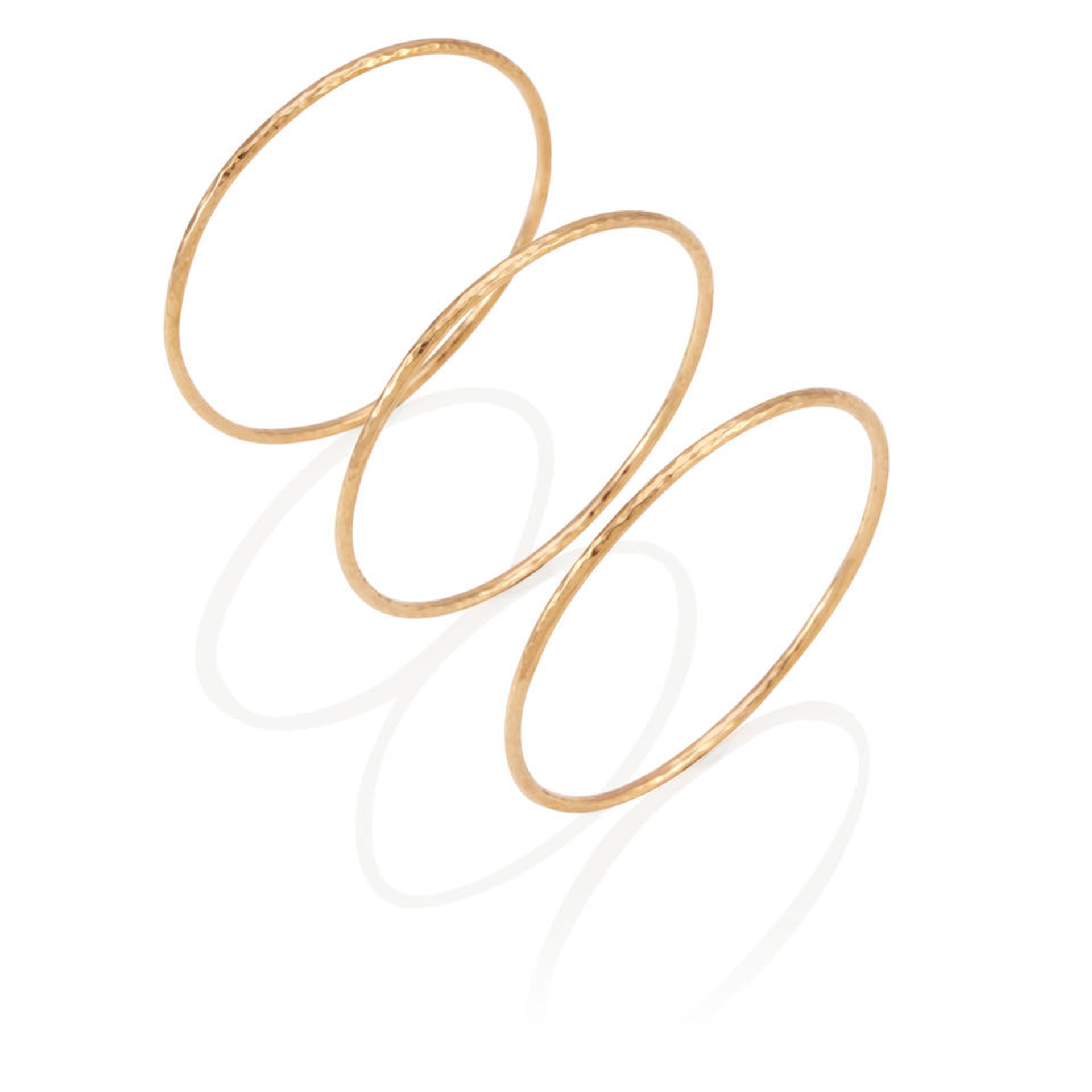 A SET OF THREE 14K GOLD BANGLE BRACELETS