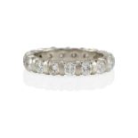 A PLATINUM AND DIAMOND ETERNITY BAND RING