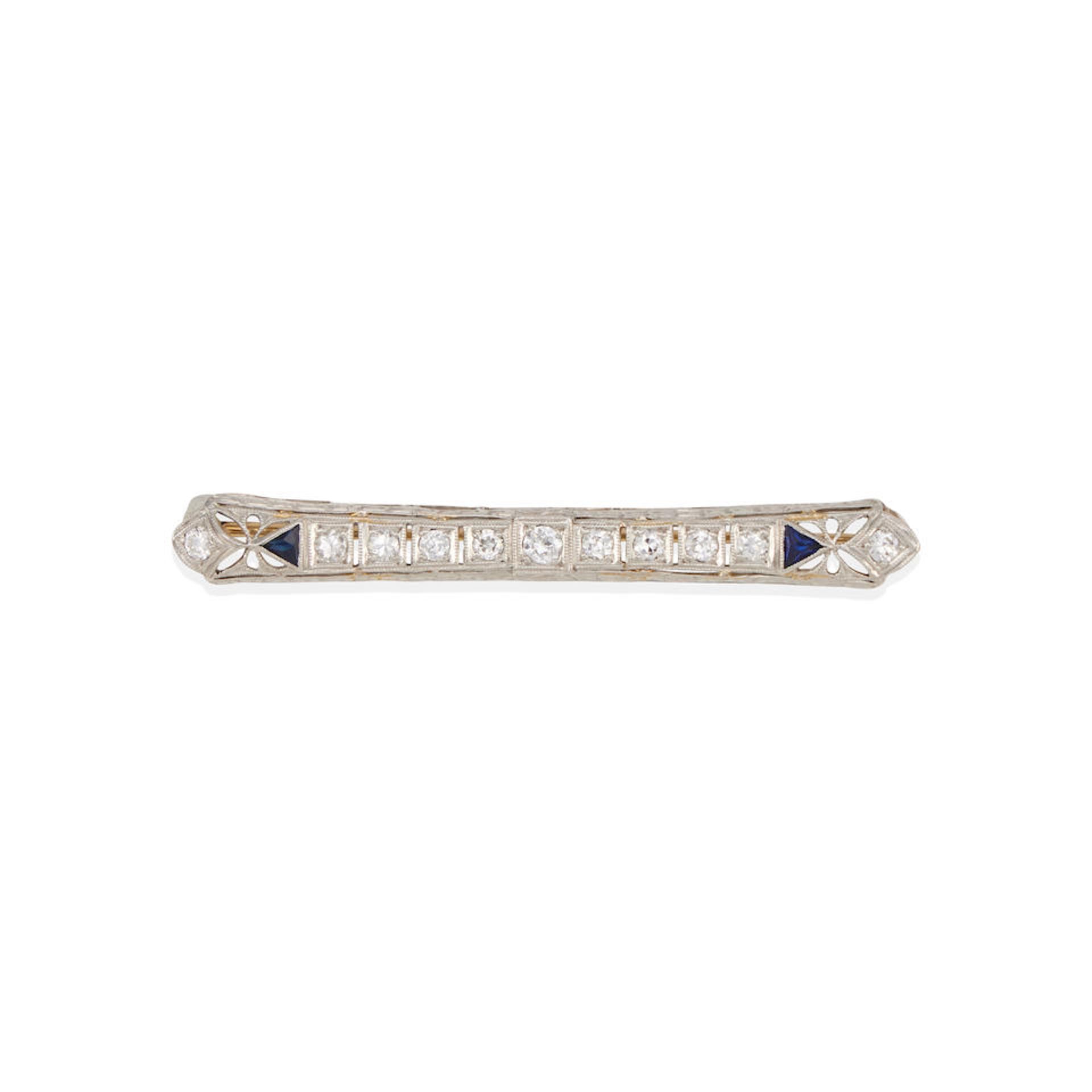 A PLATINUM, 18K WHITE GOLD, DIAMOND, AND SAPPHIRE BROOCH