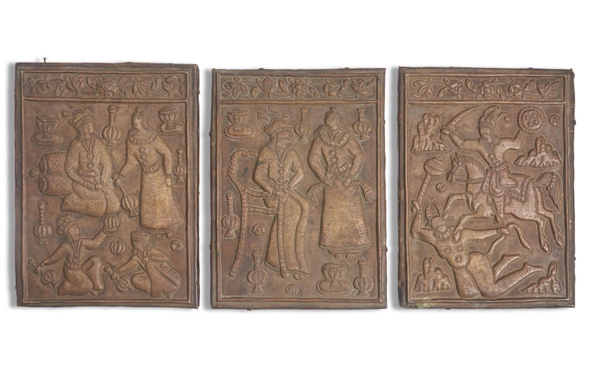 THREE PERSIAN COPPER REPOUSSE PLAQUES MOUNTED ON WOOD PANELS