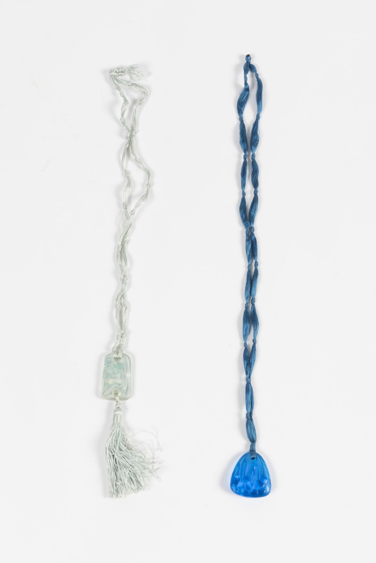 RENE LALIQUE (1860-1945) Suite de deux pendentifs en verre moul&#233; press&#233;, circa 1920