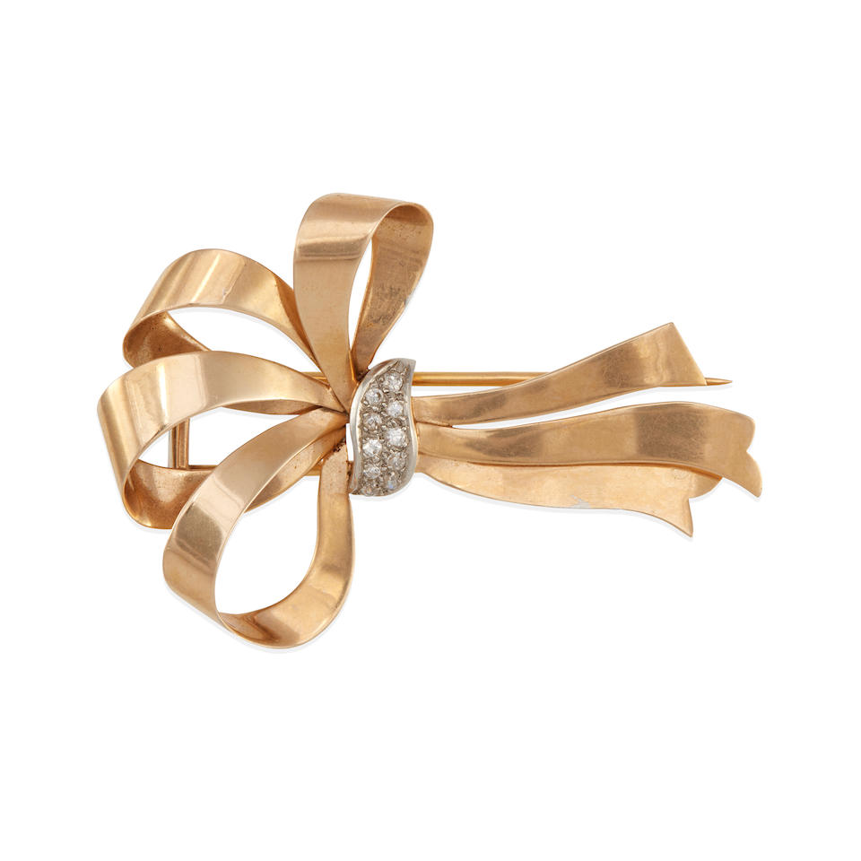 AN 18K GOLD, PLATINUM AND DIAMOND BOW BROOCH