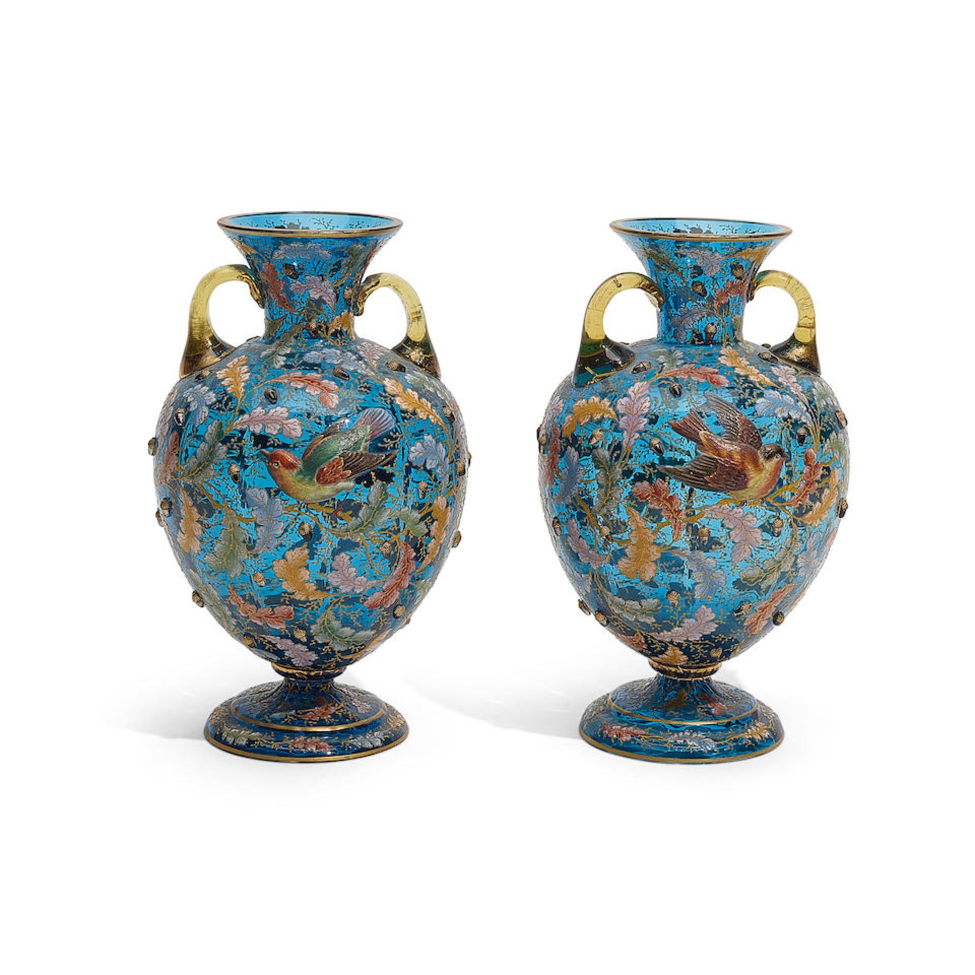 A PAIR OF MOSER ENAMELLED BLUE GLASS TWO-HANDLED FOOTED VASESEarly 20th century