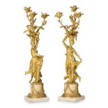 A PAIR OF LOUIS XVI STYLE GILT BRONZE AND MARBLE THREE-LIGHT FIGURAL CANDELABRAAfter the model b...