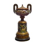A MOSER GILT AND ENAMELLED BLACK GLASS TWO-HANDLED LIDDED URN ON STANDCirca 1900