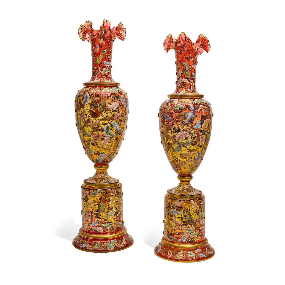 A PAIR OF MOSER GILT AND ENAMELLED AMBERLINE VASES ON STANDSLate 19th century