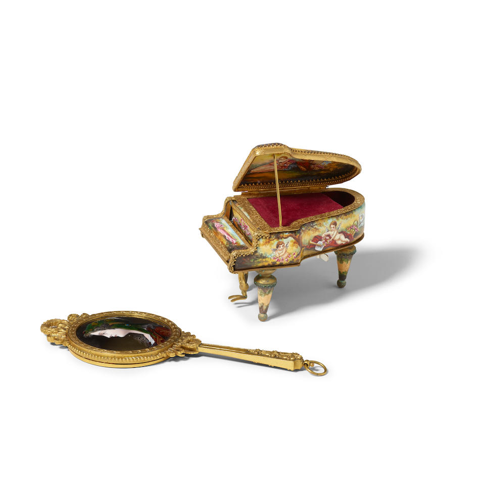 A CONTINENTAL ENAMEL AND GILT METAL PIANO-FORM MUSIC BOX AND HAND MIRRORCirca 1900