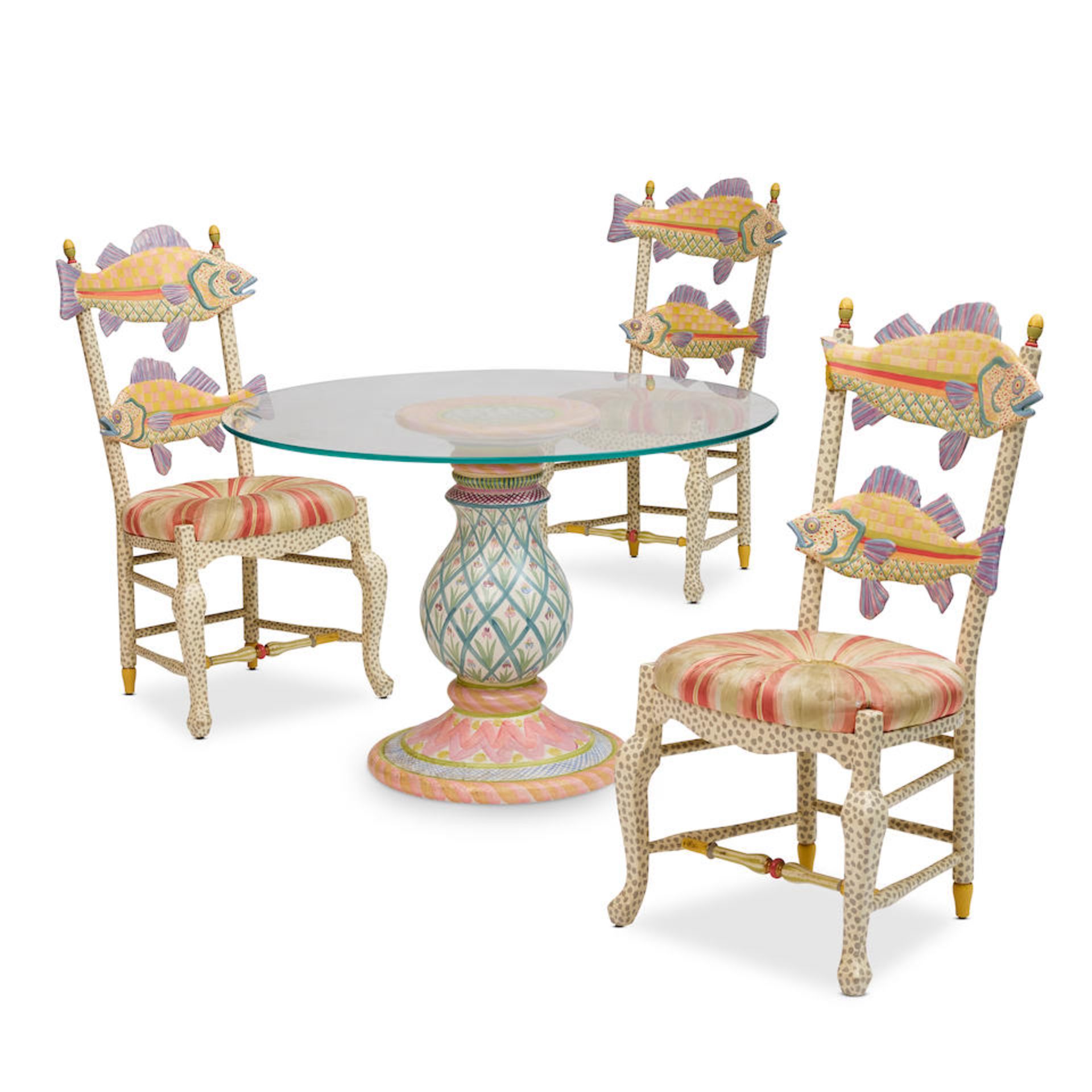 A MACKENZIE-CHILDS DINING CERAMIC TABLE AND THREE PAINTED WOOD FISH CHAIRS