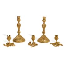 FIVE ROCOCO STYLE GILT BRONZE CANDLESTICKS