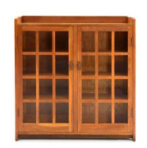 GUSTAV STICKLEY (1858-1942) DOUBLE-DOOR BOOKCASE NO. 718, Eastwood, New York, c. 1910, oak, glas...