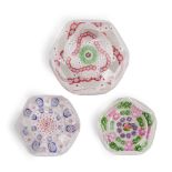 THREE FACETED PATTERNED MILLEFIORI GLASS PAPERWEIGHTS, France, paperweight with entwined garland...