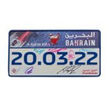 A signed Bahrain F1 commemorative license plate,