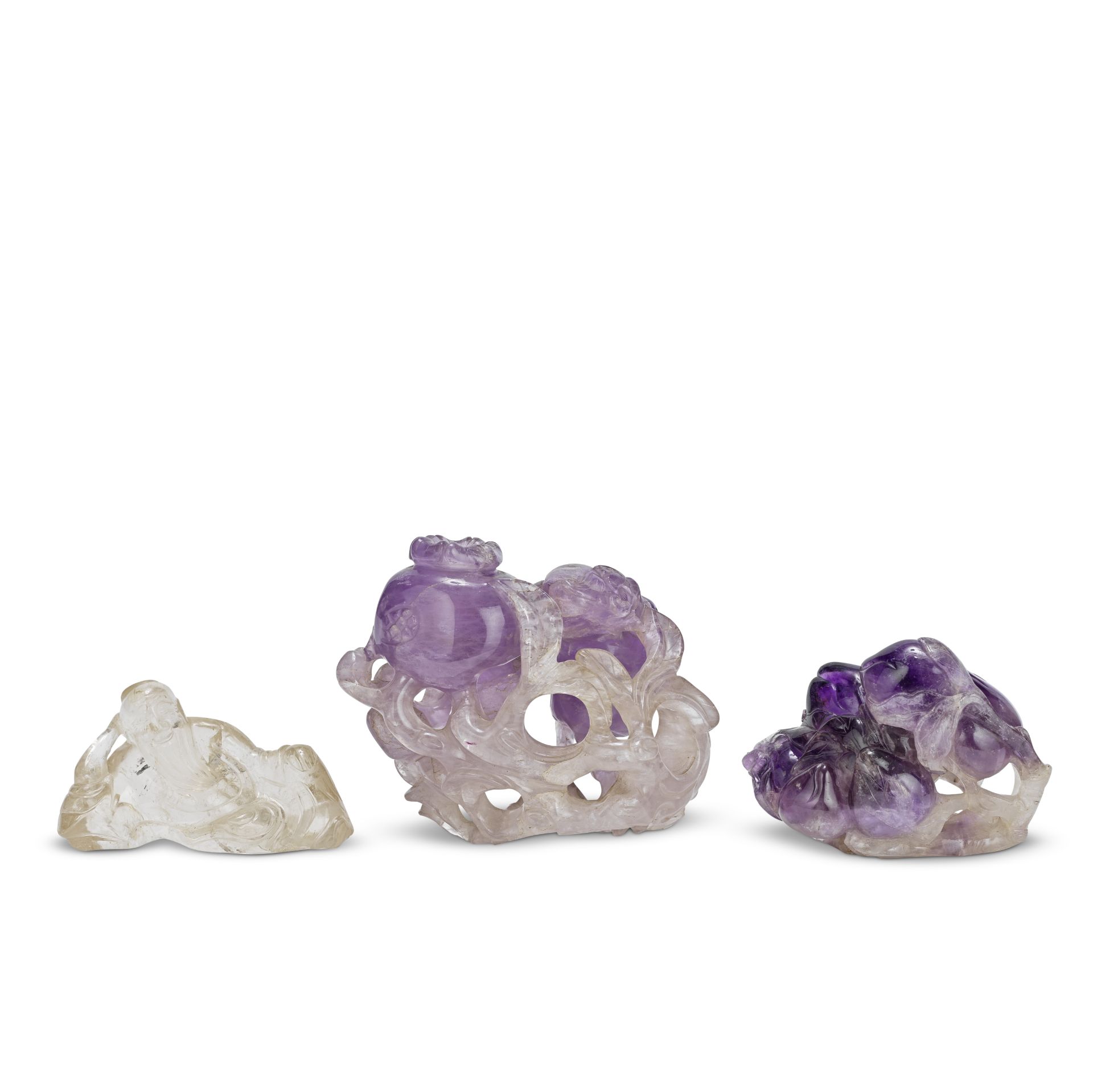 TWO CARVED AMETHYST 'FRUIT' CARVINGS AND A ROCK CRYSTAL 'LI BAI' CARVING 19th century (3)