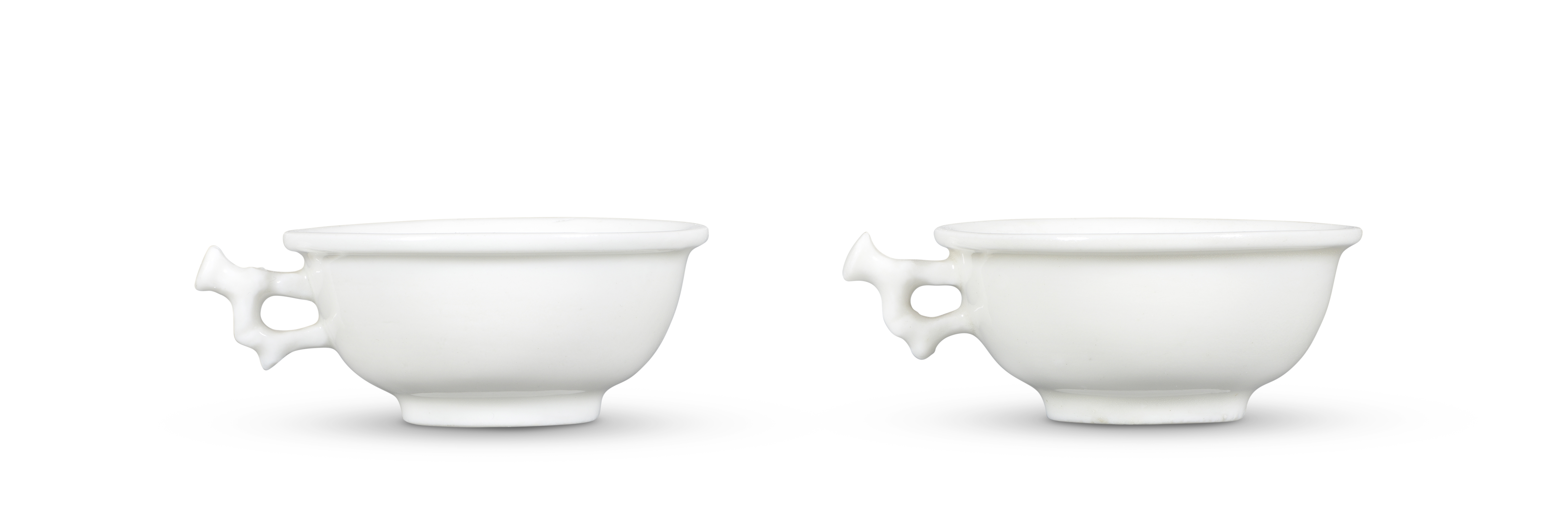 A PAIR OF BLANC-DE-CHINE 'BRANCH-HANDLED' CUPS 17th century (2)