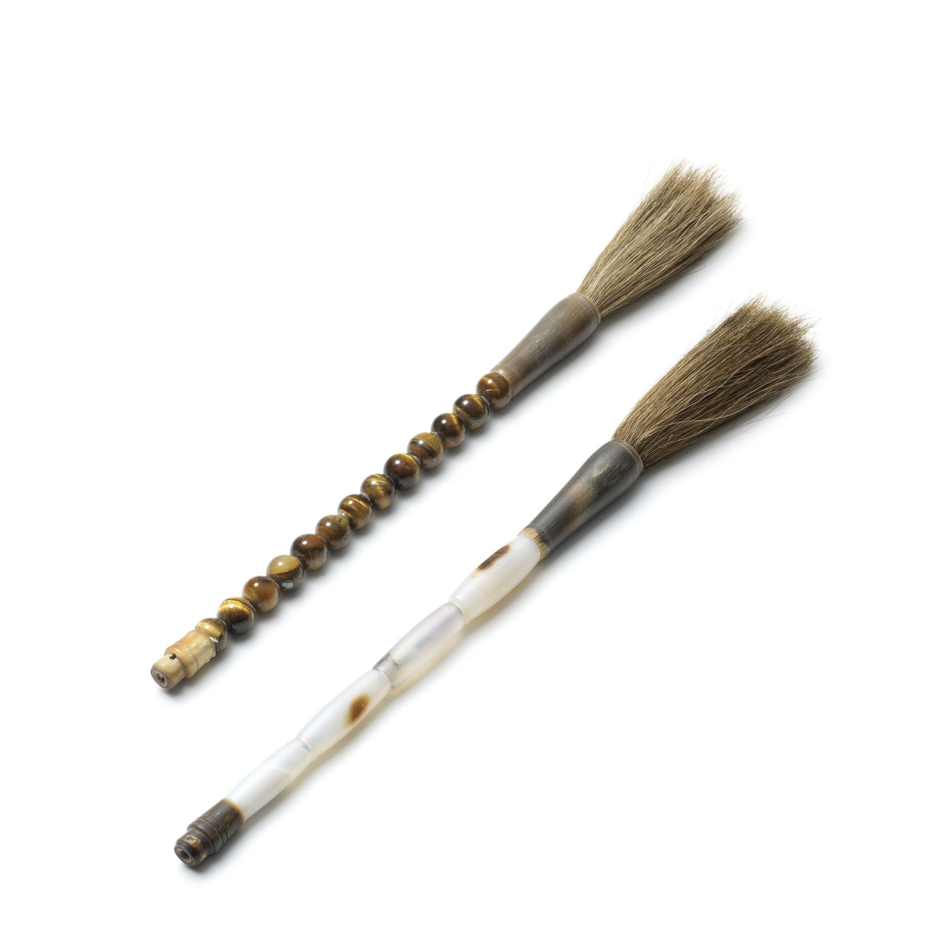 AN AGATE BRUSH HANDLE AND A TIGER'S EYE BRUSH HANDLE 19th/20th century (2)