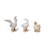 A PAIR OF PAINTED POTTERY MODELS OF GEESE AND A GREEN AND OCHRE-GLAZED POTTERY MODEL OF A DUCK T...