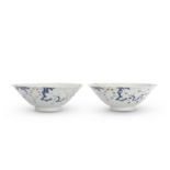 A PAIR OF UNDERGLAZE BLUE, COPPER RED AND WHITE SLIP DECORATED 'PRUNUS' BOWLS Chenghua six-char...