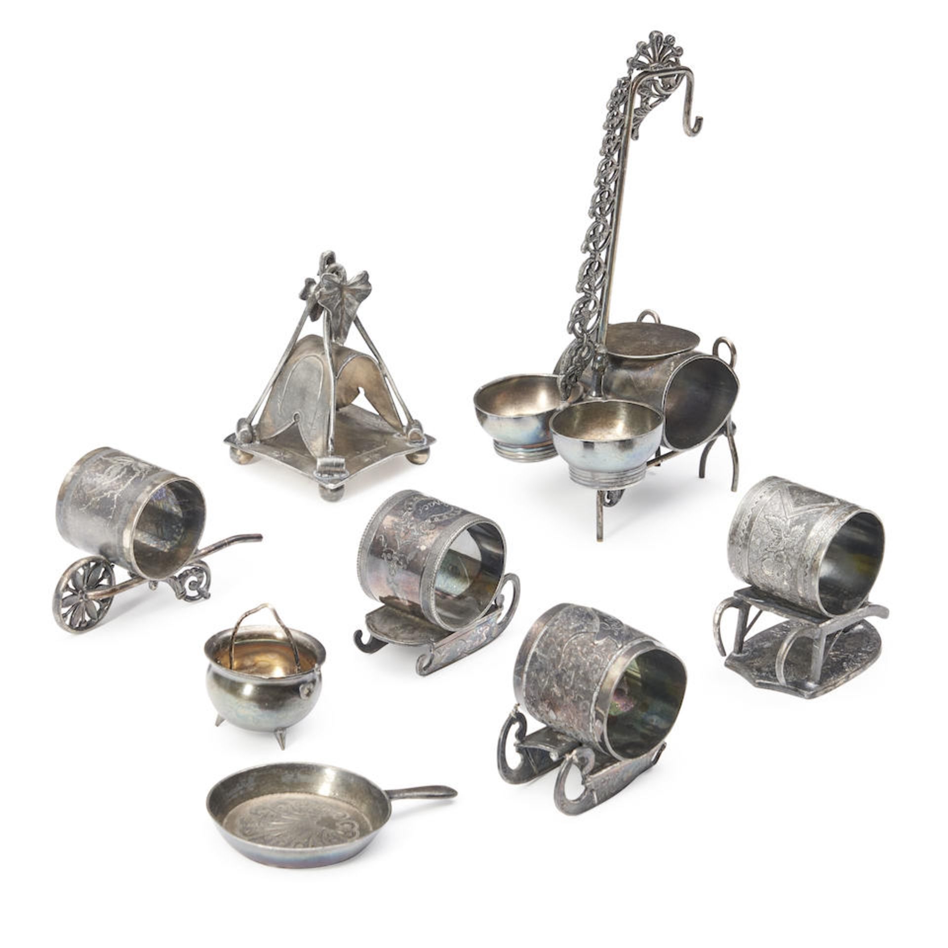 SIX SILVER-PLATED NAPKIN RINGS ON STANDS