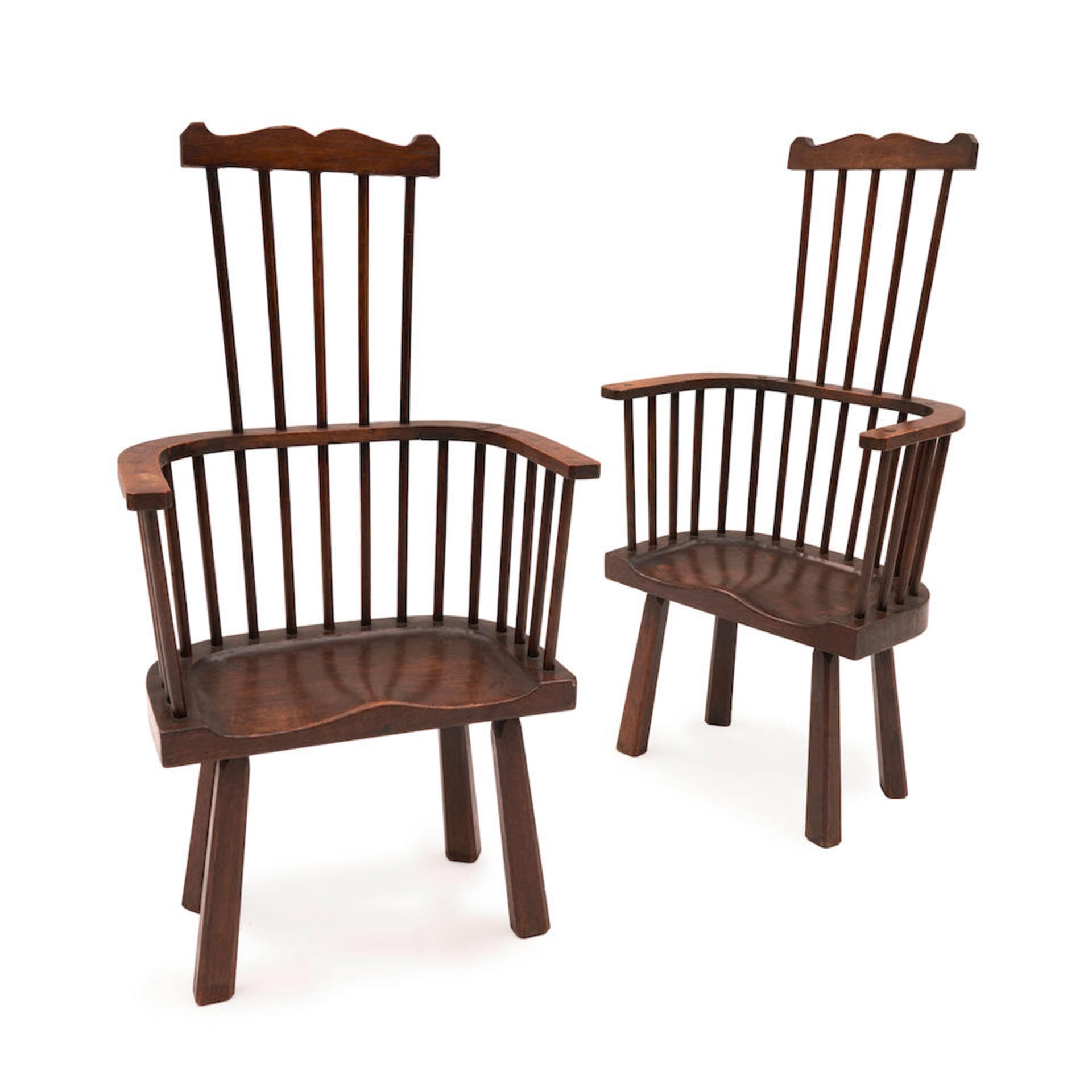 PAIR OF ARTS AND CRAFTS OAK COMB BACK ARMCHAIRS