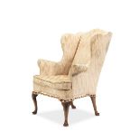 A 19th century walnut wingback armchair in the George II style