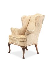 A 19th century walnut wingback armchair in the George II style