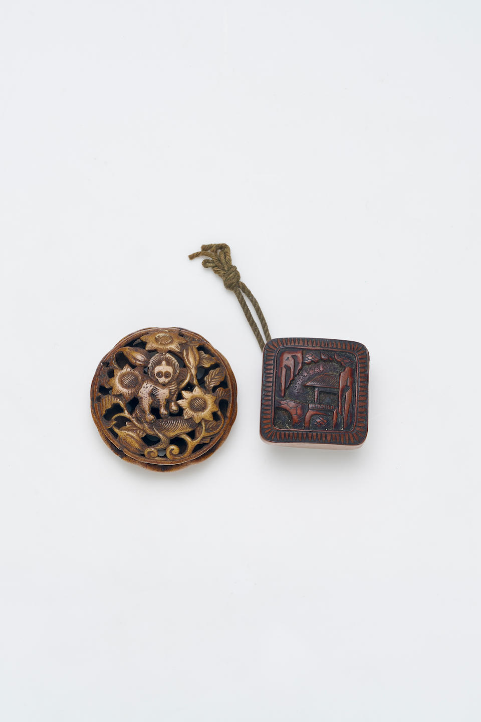 A STAG ANTLER MANJU-NETSUKE AND A WOOD HAKO-NETSUKE Edo and Meiji Period, 19th Century (2)