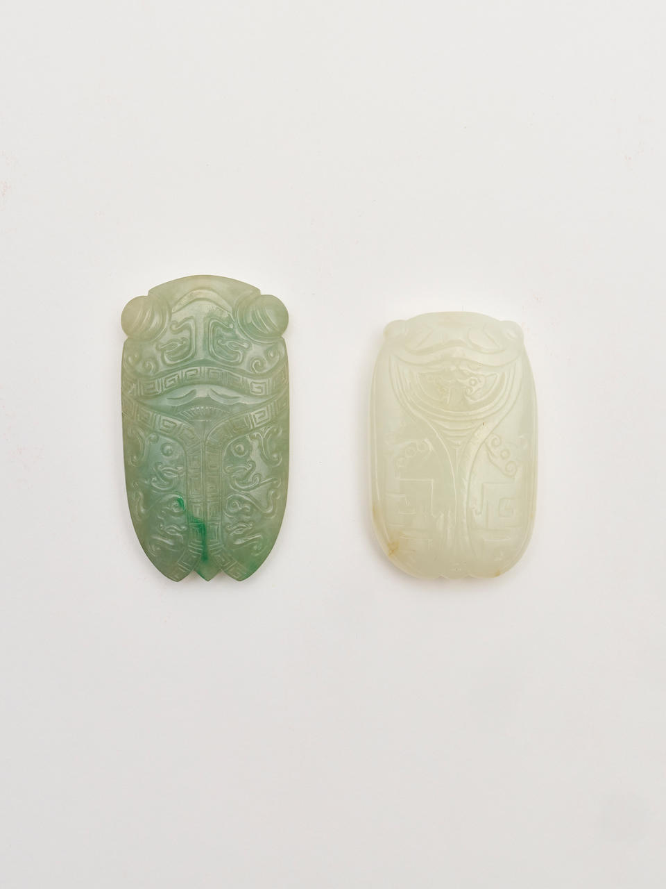 A jadeite and a white jade 'cicada' pendant 20th century (2)