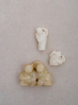 Three white and celadon jade 'child' toggles 19th/ 20th century (3)