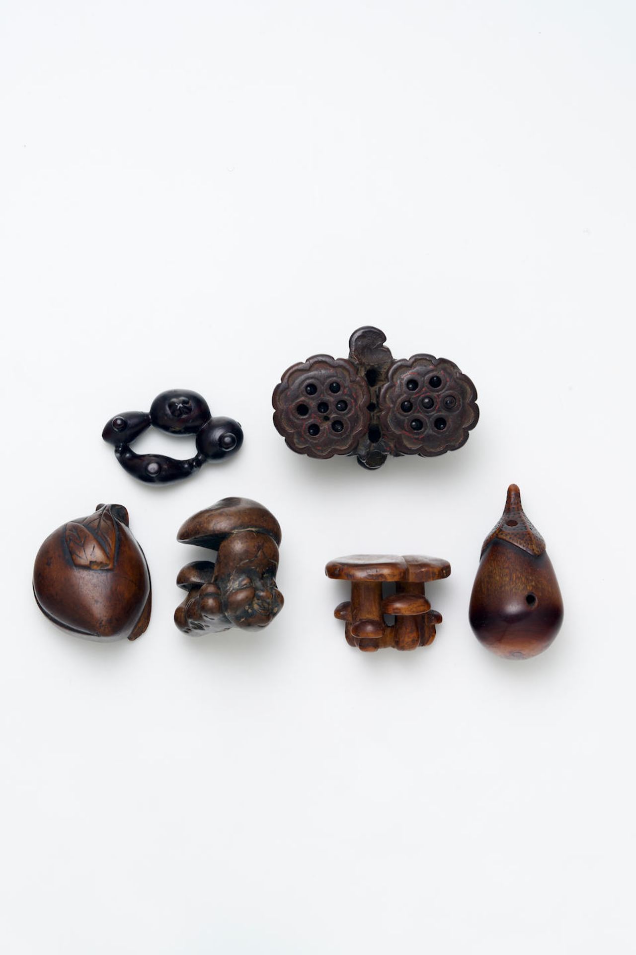 FOUR WOODEN PLANT AND FUNGUS THEME NETSUKE AND HORN AUBERGINE ROSEWOOD FRUIT AND VEGETABLE FIGUR...