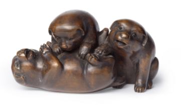 SUGUNOYA SHOKO A Wood Okimono (Table Ornament) of Three Puppies Edo period (1615-1868) or Meiji ...