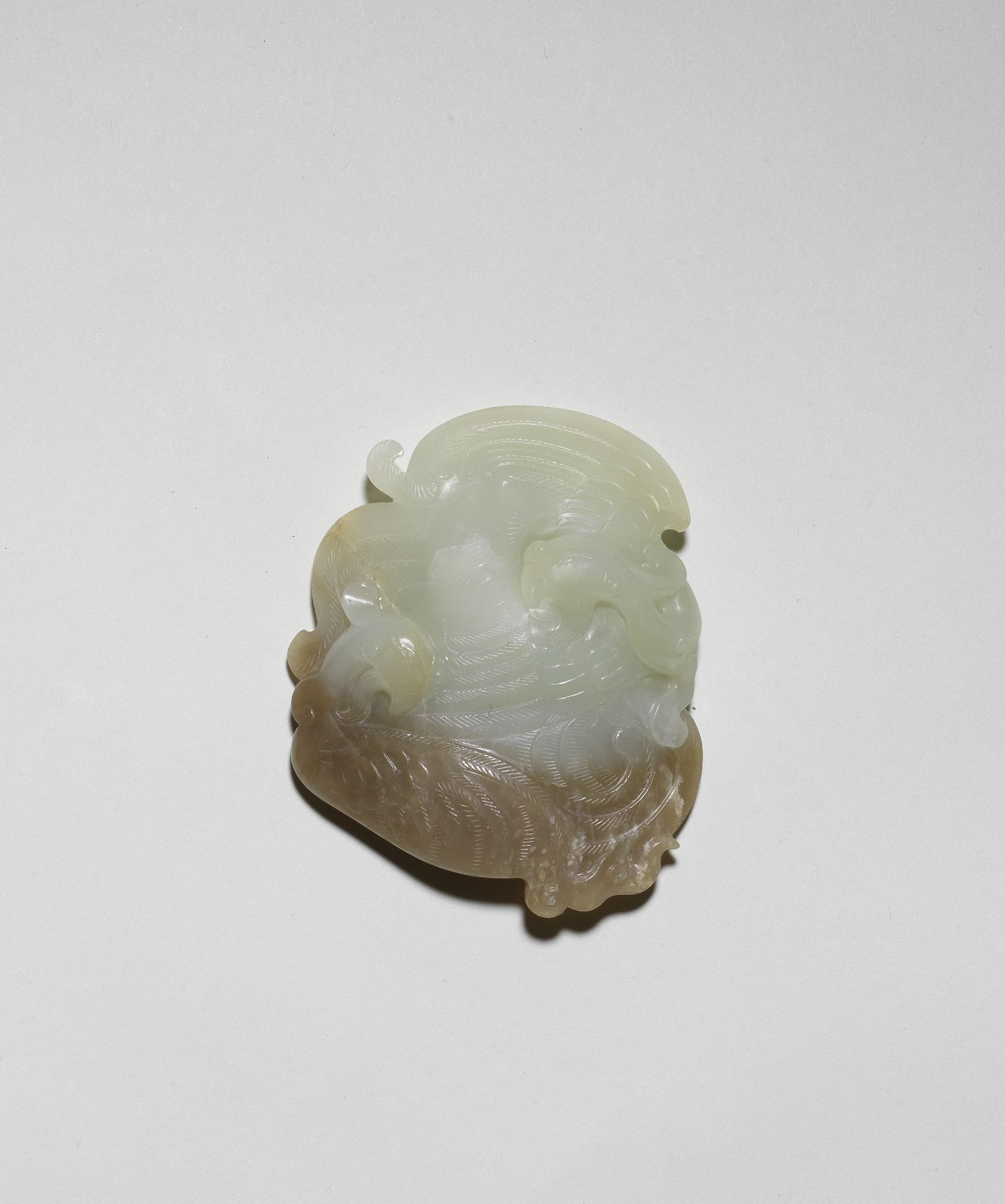 A PALE GREEN AND CHESTNUT JADE 'DOUBLE PHOENIX' SCROLL WEIGHT 18th century