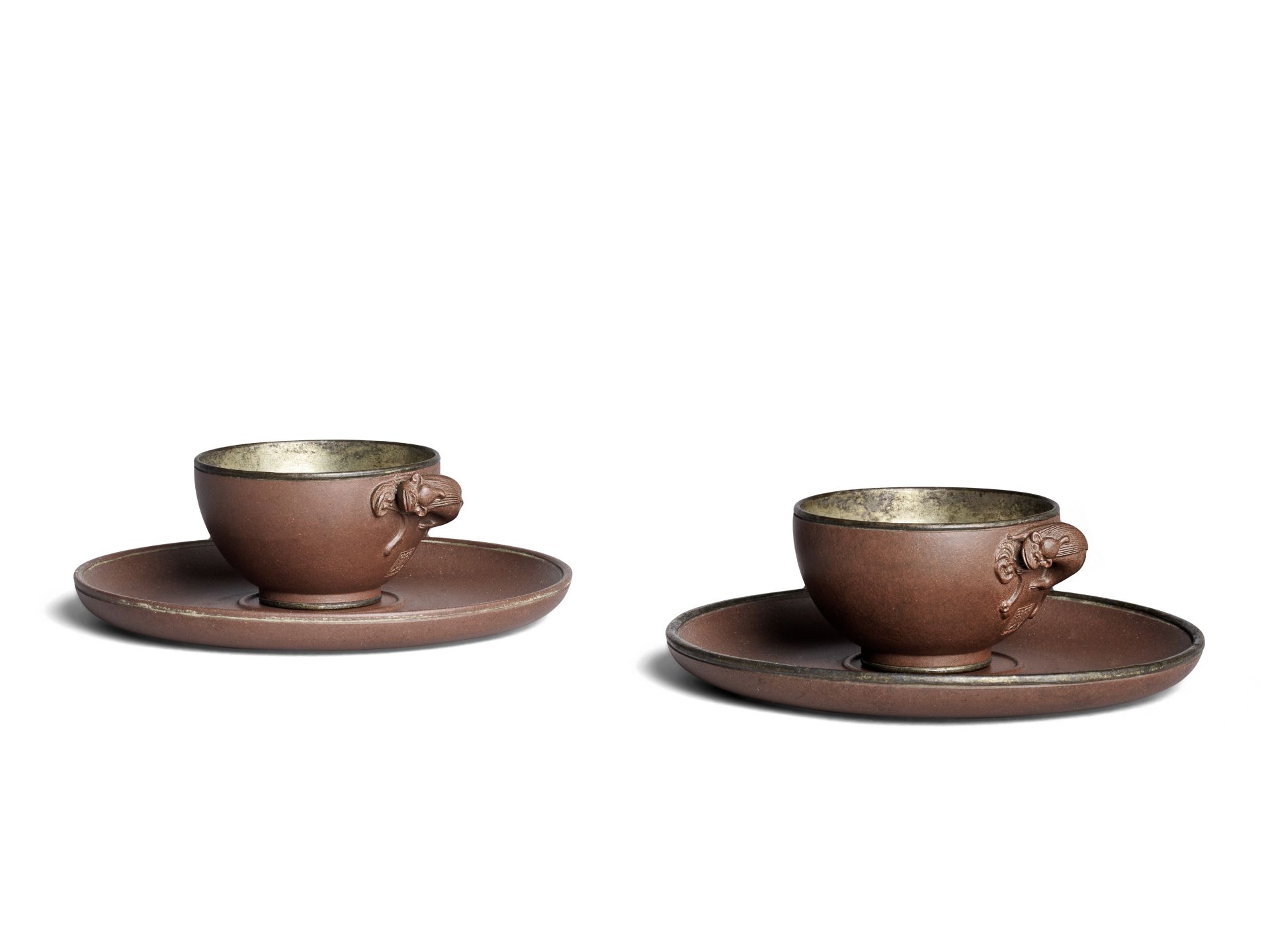 A PAIR OF YIXING STONEWARE SILVER-LINED CUPS AND SAUCERS Dicheng seal-marks, early Qing Dynasty ...