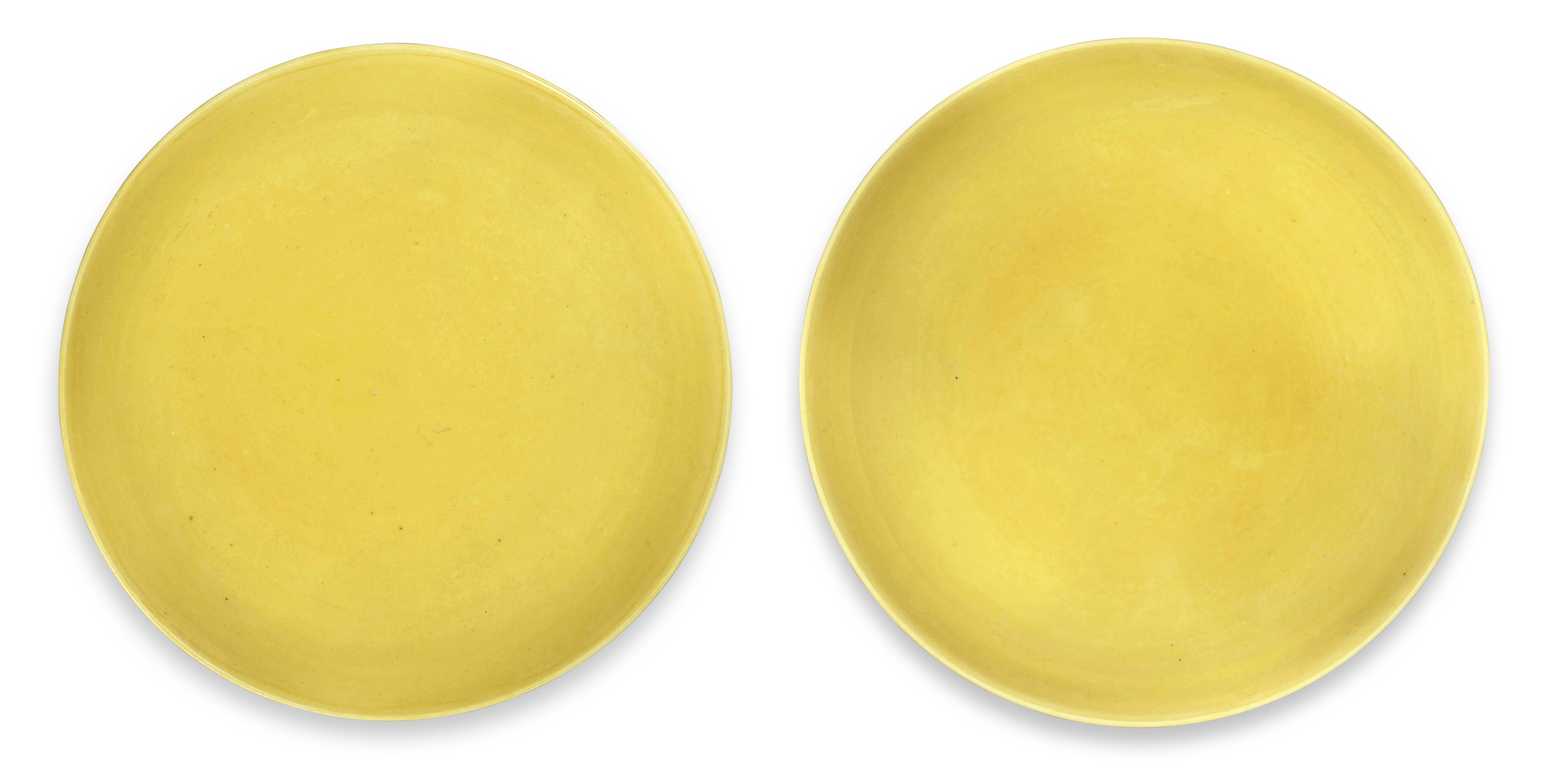 A NEAR PAIR OF IMPERIAL YELLOW-GLAZED SAUCER DISHES Yongzheng six-character marks and of the per...