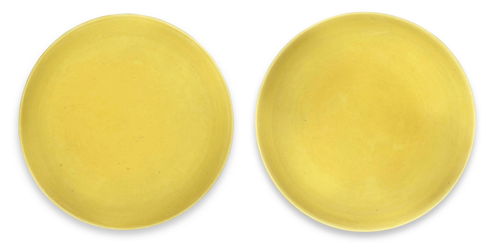 A NEAR PAIR OF IMPERIAL YELLOW-GLAZED SAUCER DISHES Yongzheng six-character marks and of the per...