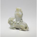 A PALE GREEN AND RUSSET JADE DEER AND VASE GROUP 17th/18th century