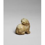 A PALE GREEN AND RUSSET JADE CARVING OF A MYTHICAL BEAST Ming Dynasty