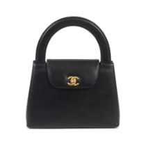 Karl Lagerfeld for Chanel: a Black Caviar Leather Top Handle Kelly Bag 1997-99 (includes serial ...