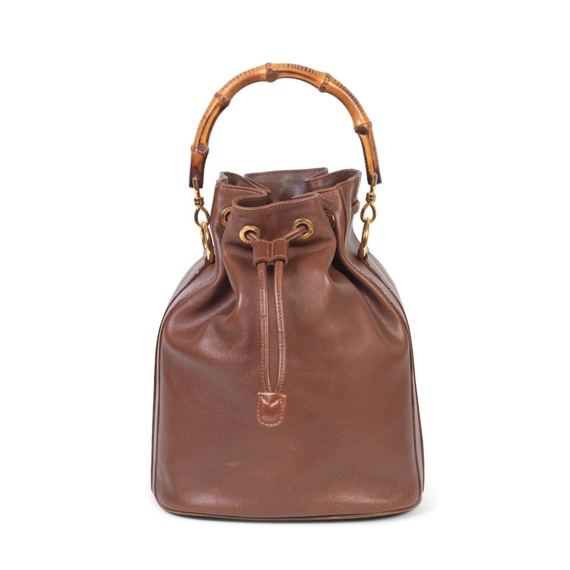 Gucci: a Brown Leather Bamboo Bucket Bag 1990s (includes dust bag)