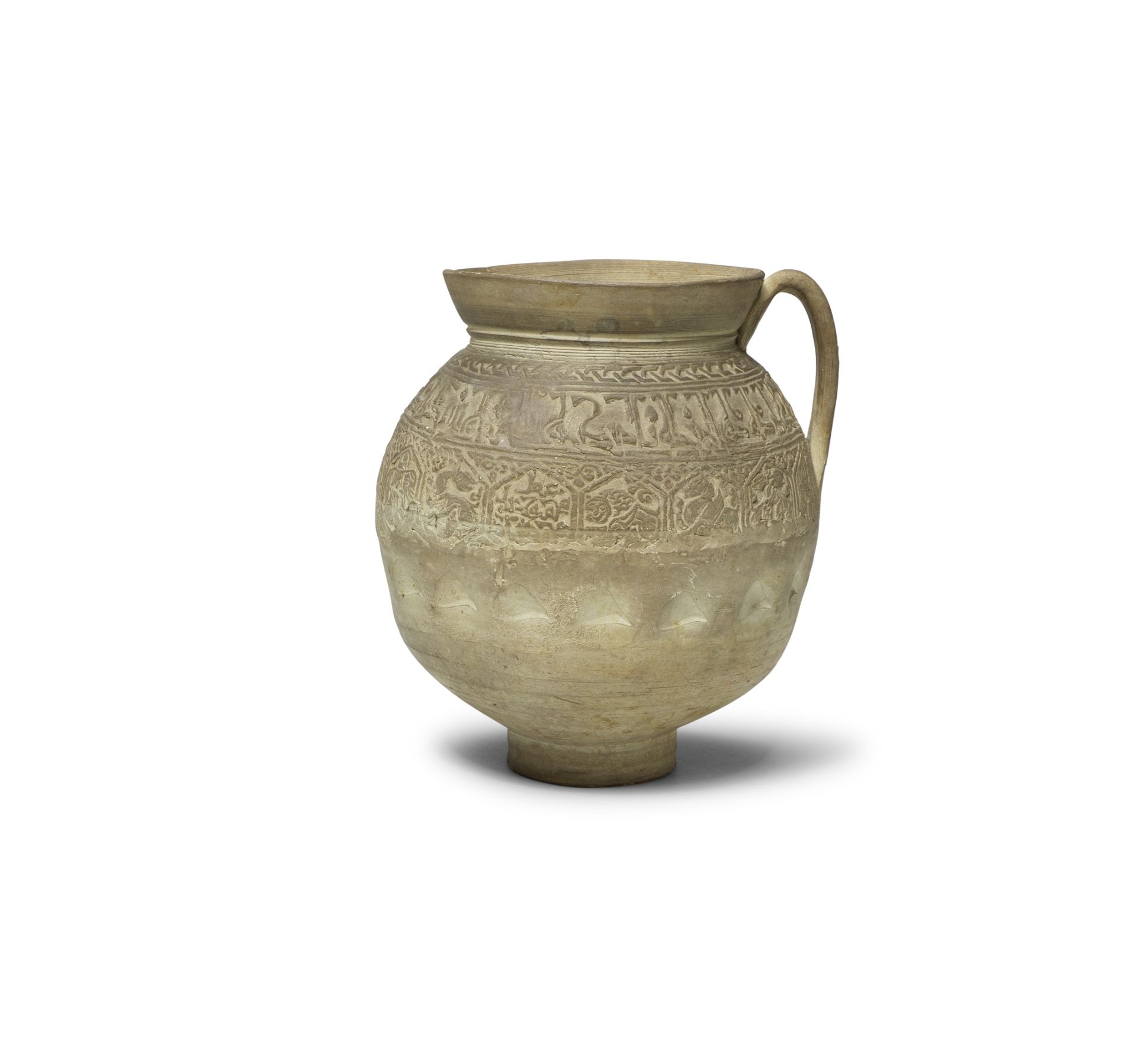 An unglazed moulded pottery jug Mesopotamia, 11th/ 12th Century